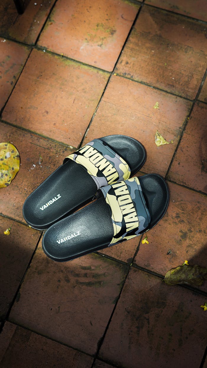 Fashionable slides on a brick floor, perfect for casual wear.